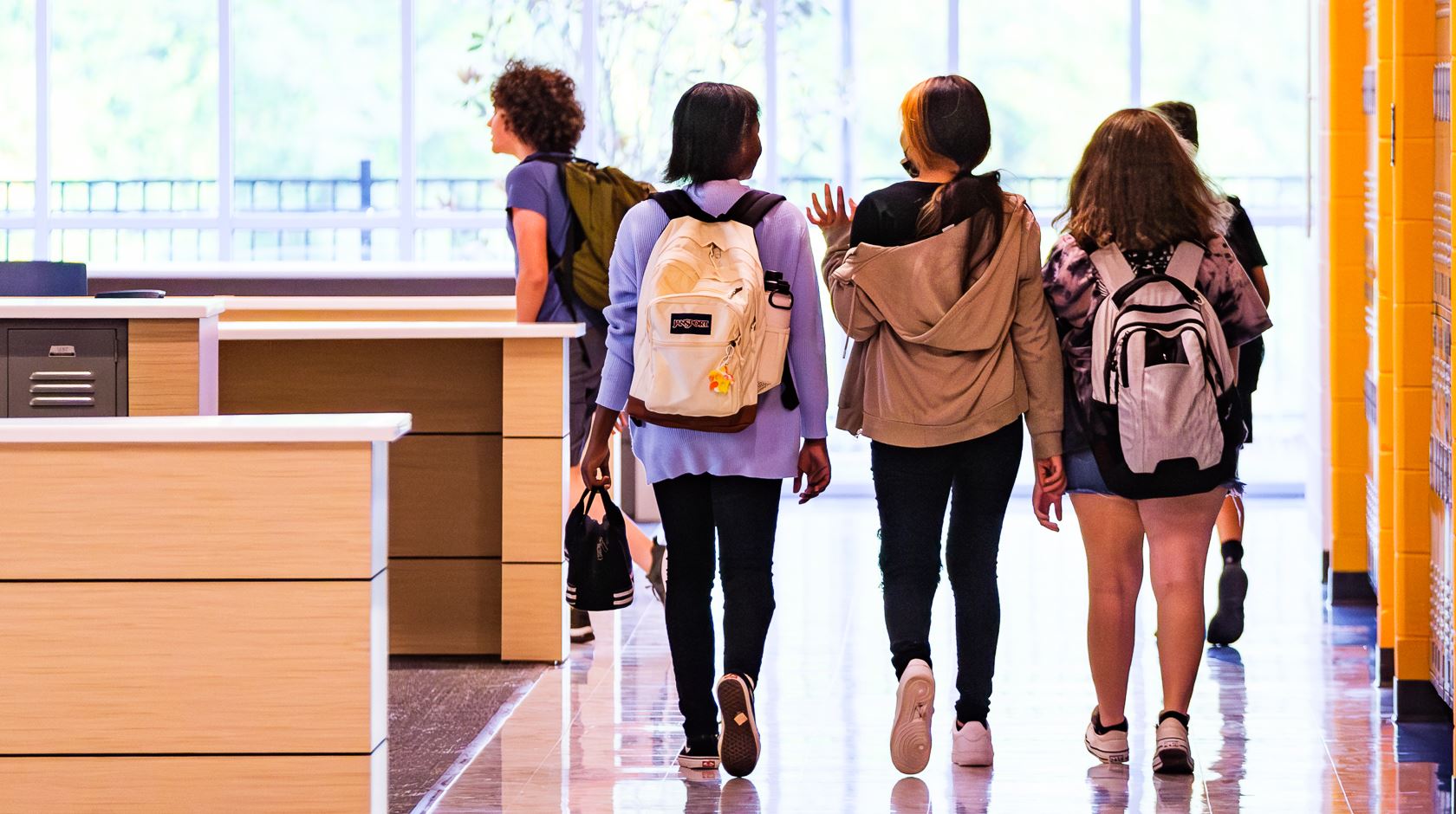  Students walking in the hallway at school.